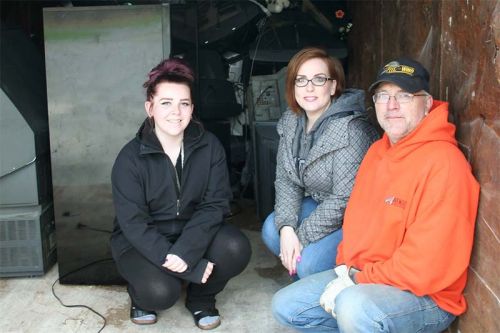 Hailey Hickey, Tina McHale and Mike Williams with what had been collected to 11:30 p.m. Photo/Craig Bakay